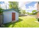Backyard featuring a shed, large lawn, and wood fence with mature trees at 5 E Jefferson St, Maxwell, IN 46154
