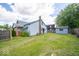 Exterior view of house and backyard with shed, lawn, and brick chimney at 5 E Jefferson St, Maxwell, IN 46154