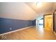 Spacious bedroom features modern flooring, blue accent wall, and attached bathroom at 5 E Jefferson St, Maxwell, IN 46154