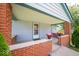 Inviting covered porch with brick accents and well-placed plants, creating a welcoming entrance at 5 E Jefferson St, Maxwell, IN 46154