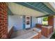 Welcoming front porch featuring brick columns, providing a cozy outdoor entrance with a clear view at 5 E Jefferson St, Maxwell, IN 46154