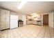 Open kitchen with neutral cabinets, stainless steel appliances, and tile flooring at 5 E Jefferson St, Maxwell, IN 46154