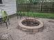The backyard has a stone firepit, great for relaxing and entertaining in the outdoor space at 513 Andover Rd, Anderson, IN 46013