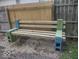 The backyard features a simple wooden bench, perfect for enjoying the outdoors at 513 Andover Rd, Anderson, IN 46013