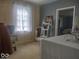 A serene bedroom featuring wood-paneled walls and natural light, creating a peaceful retreat at 513 Andover Rd, Anderson, IN 46013