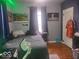 This is a cozy bedroom with a gamer's desk set-up and a comfy looking bed at 513 Andover Rd, Anderson, IN 46013