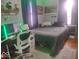 This is a cozy bedroom with a gamer's desk set-up and a comfy looking bed at 513 Andover Rd, Anderson, IN 46013