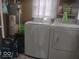 A functional laundry room equipped with a washer and dryer, and upper shelving for storage at 513 Andover Rd, Anderson, IN 46013