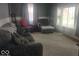 Comfortable living room featuring a large window that allows natural light in to illuminate the carpet at 513 Andover Rd, Anderson, IN 46013