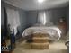 Bedroom with calm gray walls, large bed, and dresser at 513 Andover Rd, Anderson, IN 46013