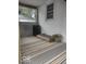 This is a covered patio area with an outdoor rug and a seating arrangement at 513 Andover Rd, Anderson, IN 46013