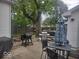 Backyard patio with grills, dining table and a large shade tree at 513 Andover Rd, Anderson, IN 46013