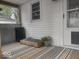 This is a covered patio area with an outdoor rug and a seating arrangement at 513 Andover Rd, Anderson, IN 46013