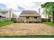 This backyard has a level, grassy lawn enclosed by a wooden fence with the house in the background at 5240 Ochs Ave, Indianapolis, IN 46254