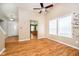 Spacious living room featuring hardwood floors, a fan, and natural light at 5240 Ochs Ave, Indianapolis, IN 46254