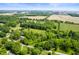 Vast aerial view showcasing a beautiful property surrounded by verdant fields and lush trees at 5253 W 8Th Street Rd, Anderson, IN 46011