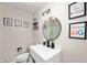 Bathroom featuring modern fixtures, a white vanity, decorative lighting, and artwork at 5253 W 8Th Street Rd, Anderson, IN 46011