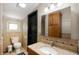 Cozy bathroom with granite countertops, earth tone tile, and a decorative mirror at 5253 W 8Th Street Rd, Anderson, IN 46011