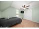 Cozy upstairs bedroom with neutral carpet, a closet, and a ceiling fan at 5253 W 8Th Street Rd, Anderson, IN 46011