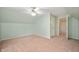 Clean upstairs bedroom with neutral carpet, a window, closet, and a hall door at 5253 W 8Th Street Rd, Anderson, IN 46011