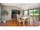 Bright dining area showcasing a table with seating, sunroom style, and sliding door at 5253 W 8Th Street Rd, Anderson, IN 46011