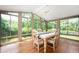 Sunlit dining room with floor to ceiling windows, a ceiling fan, and seating for six at 5253 W 8Th Street Rd, Anderson, IN 46011