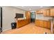 Spacious kitchen with wood cabinets, granite countertops, and a decorative sign on the wall at 5253 W 8Th Street Rd, Anderson, IN 46011