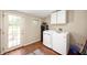 Functional laundry room with modern washer and dryer, laminate floors, and ample storage at 5253 W 8Th Street Rd, Anderson, IN 46011