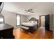 Large main bedroom with hardwood floors, a ceiling fan, and a king-sized bed at 5253 W 8Th Street Rd, Anderson, IN 46011