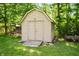 Charming outdoor storage shed with double doors nestled in a wooded area, perfect for garden tools and storage solutions at 5253 W 8Th Street Rd, Anderson, IN 46011