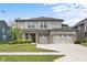 Beautiful two-story home with a three-car garage and a well-manicured lawn at 5264 Veranda Dr, Noblesville, IN 46062
