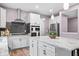 Open kitchen with a large granite island, stainless steel appliances, and light gray backsplash at 5264 Veranda Dr, Noblesville, IN 46062