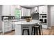 Bright kitchen features a granite island with seating, stainless steel appliances, and light gray backsplash at 5264 Veranda Dr, Noblesville, IN 46062