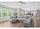 Bright living room with large windows, open to the kitchen, and a comfortable sectional sofa at 5264 Veranda Dr, Noblesville, IN 46062