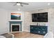 Living room featuring a decorative wall, fireplace, stylish blue cabinet, and recessed lighting at 5264 Veranda Dr, Noblesville, IN 46062