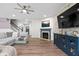 Cozy living room featuring a decorative wall, fireplace, and a stylish blue cabinet at 5264 Veranda Dr, Noblesville, IN 46062