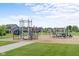 Community playground featuring a climbing structure, swings, and a slide at 5264 Veranda Dr, Noblesville, IN 46062