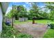 Exterior shot of backyard featuring a basketball hoop, barrel, and overgrown grass at 5349 Culver St, Indianapolis, IN 46226