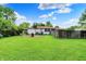 Exterior shot of backyard featuring a barrel, green grass, and wooden fence at 5349 Culver St, Indianapolis, IN 46226