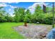 Exterior shot of backyard featuring a basketball hoop, barrel, and overgrown grass at 5349 Culver St, Indianapolis, IN 46226