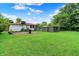 Exterior shot of backyard featuring a barrel, green grass, and wooden fence at 5349 Culver St, Indianapolis, IN 46226