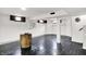 Open basement area features wood-trimmed windows and dark laminate flooring at 5349 Culver St, Indianapolis, IN 46226