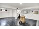 Open basement area features stairs, a bar and dark laminate flooring at 5349 Culver St, Indianapolis, IN 46226