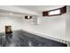 Open basement area features unique flooring and wood-trimmed windows at 5349 Culver St, Indianapolis, IN 46226