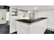 Basement bar with white cabinetry and black countertop offers a retro serving space at 5349 Culver St, Indianapolis, IN 46226