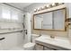 Bathroom features a vanity, large mirror, updated shower with accessibility grab bars at 5349 Culver St, Indianapolis, IN 46226