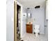Cozy bathroom features a wooden vanity, toilet, and linoleum flooring at 5349 Culver St, Indianapolis, IN 46226