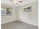 Well-lit bedroom features neutral walls and carpet, enhanced by natural light from two windows at 5349 Culver St, Indianapolis, IN 46226