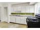 Traditional kitchen featuring ample counter space, white cabinetry, and modern appliances for cooking at 5349 Culver St, Indianapolis, IN 46226