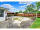 Empty swimming pool featuring a concrete deck and surrounded by overgrown grass at 5349 Culver St, Indianapolis, IN 46226